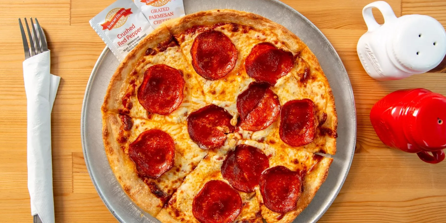 Close-up of halal beef pepperoni pizza with melted mozzarella and hand-tossed crust, freshly baked at Castello Pizza & Pasta in Seattle.